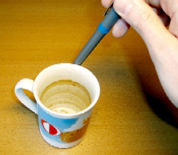 With a pen a standing wave in a coffee cup is excited